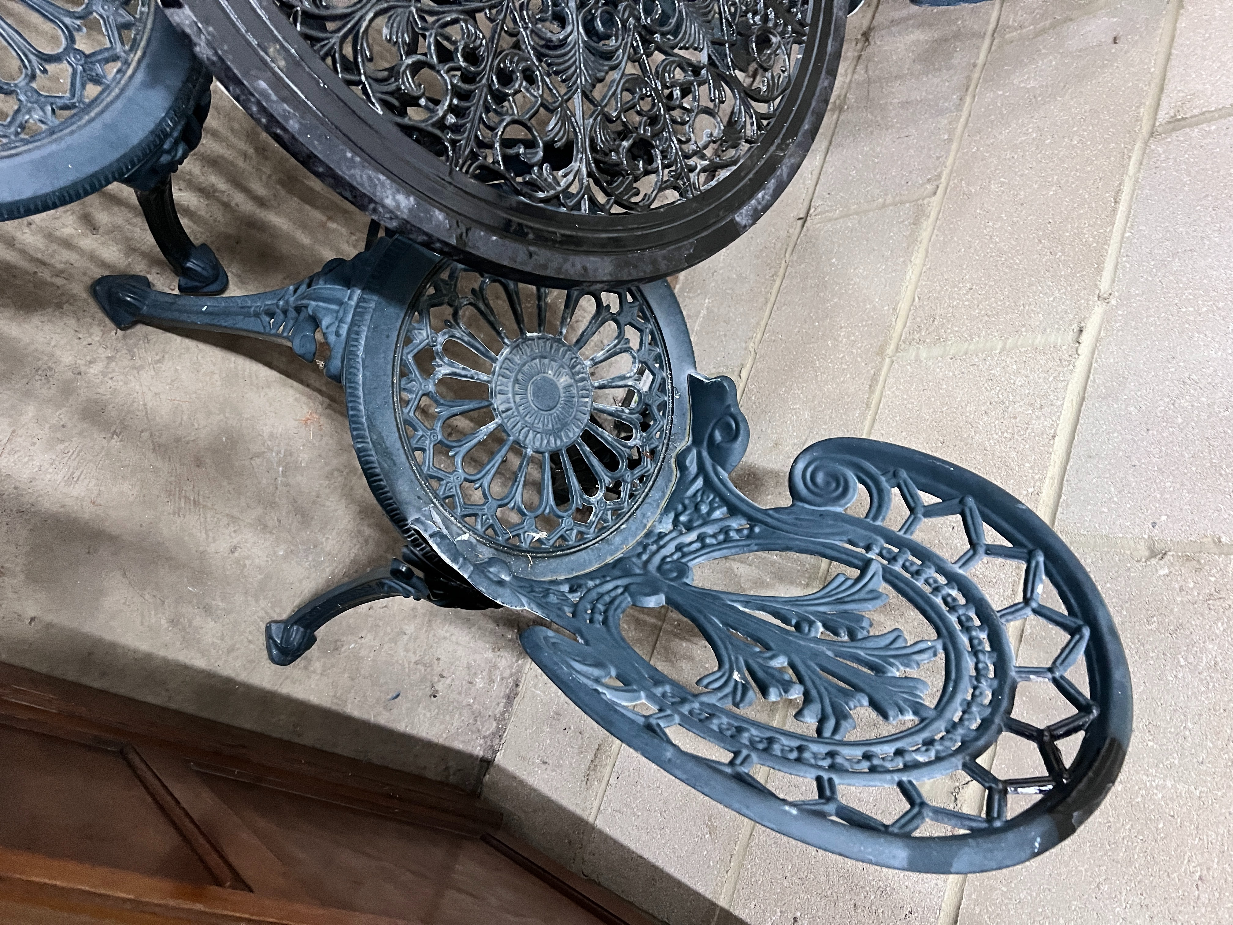 A Victorian style aluminium circular garden table, diameter 60cm, height 62cm and four chairs